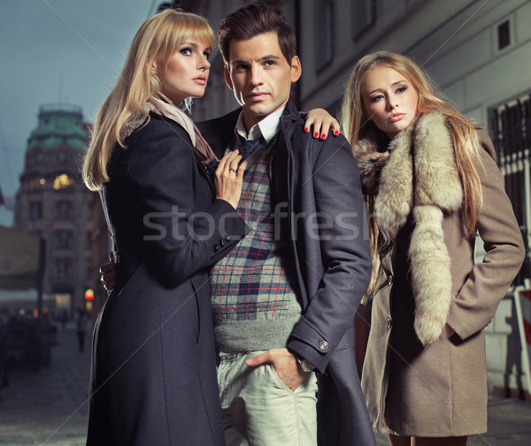 Old fashion man with company of two cute women Stock photo © konradbak