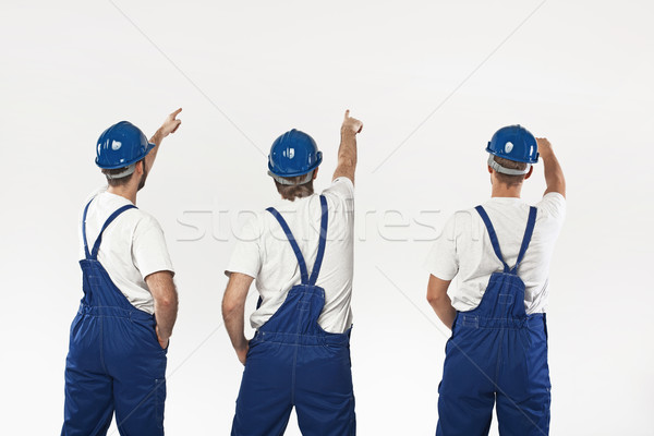 Three builders making a renovation Stock photo © konradbak