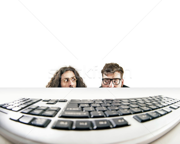 Two nerds staring at a keyboard Stock photo © konradbak