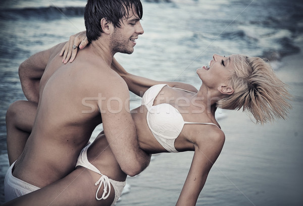 Alegre casal praia nuvens natureza mar Foto stock © konradbak