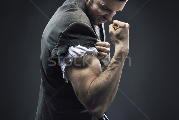 Fit businessman making the muscles Stock photo © konradbak