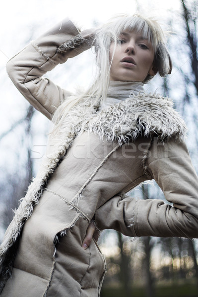 Portrait of an attractive girl wearing white fur Stock photo © konradbak