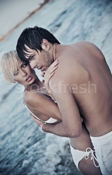 Handsome lovers by the sea Stock photo © konradbak