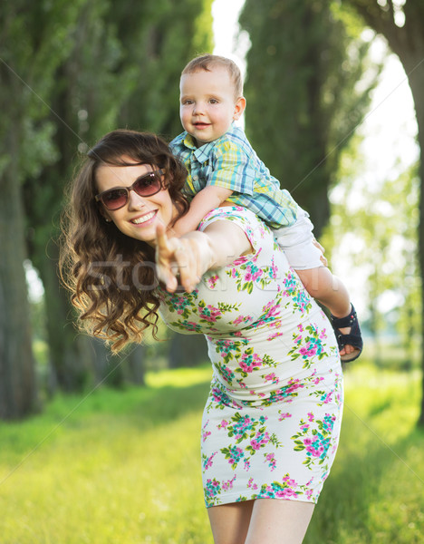 Stock photo: Laughing mom playing with her baby child