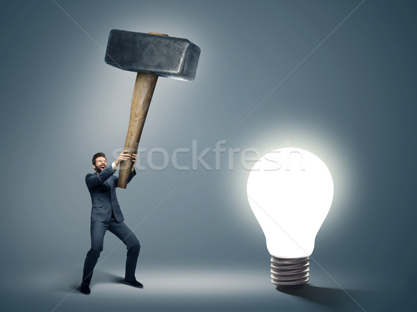 Conceptual image of a businessman holding huge hammer Stock photo © konradbak