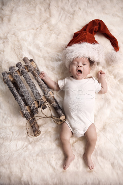 Yawning newborn child wearing a santa's hat Stock photo © konradbak