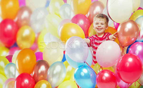 Laughing boy playing among the baloons Stock photo © konradbak