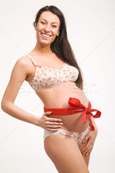Cheerful pregnant woman , cockade on abdomen Stock photo © konradbak
