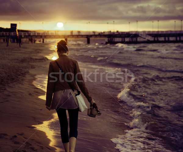 Art picture of woman with the sunset in the background Stock photo © konradbak