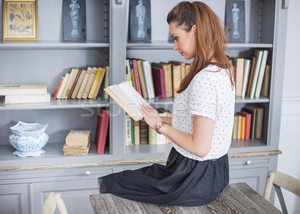 Elegant lady reading an interesting book Stock photo © konradbak