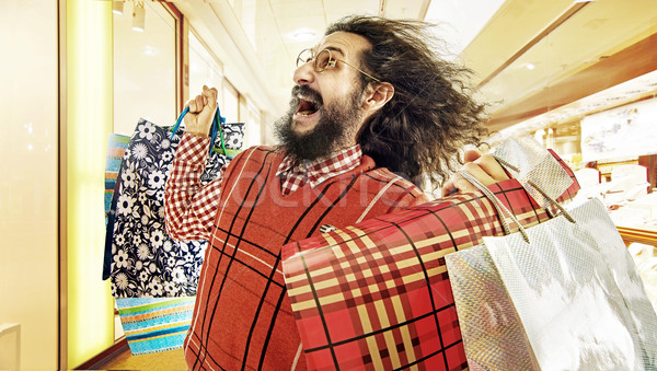 Funny image of geek guy during a sale madness Stock photo © konradbak