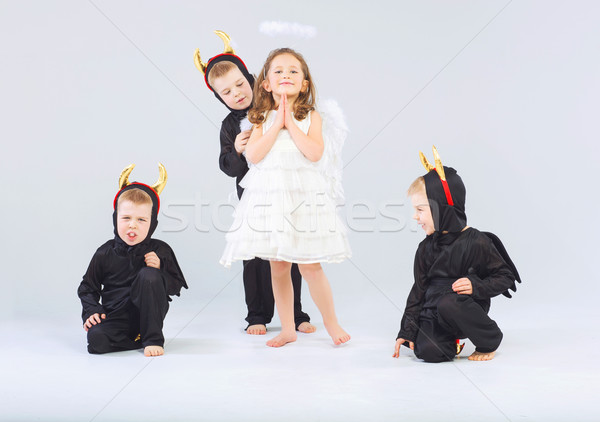 Little angel and three devils Stock photo © konradbak