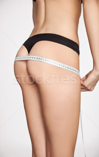 Stock photo: woman measuring her shape
