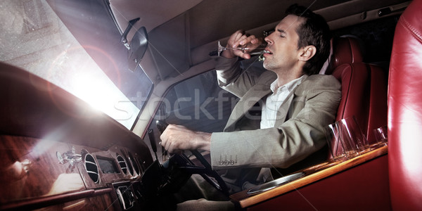 Handsome man drinking in the car Stock photo © konradbak
