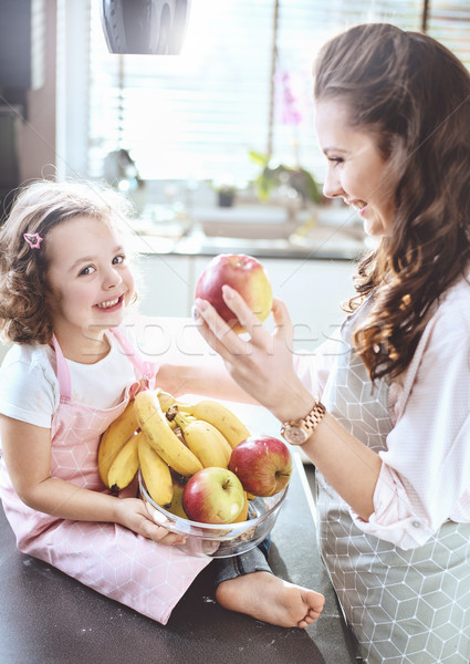 Cheerful family in a kitchen - fruit diet theme Stock photo © konradbak