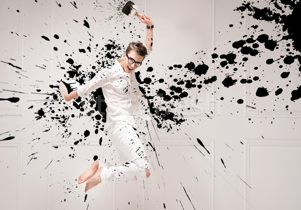 Conceptual portrait of a jumping painter Stock photo © konradbak