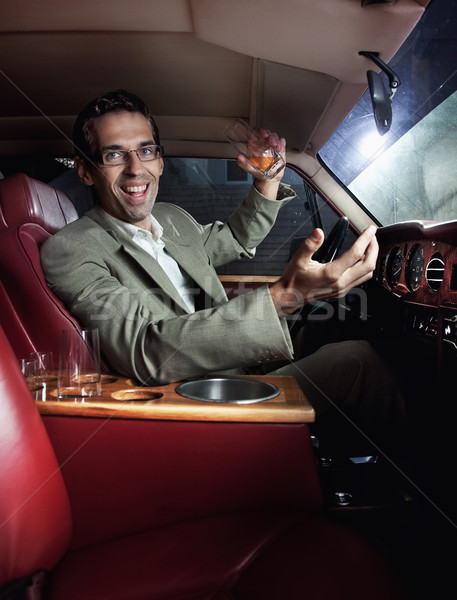 Happy man in the car drinking Stock photo © konradbak