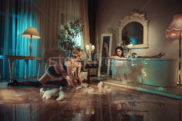 Conceptual picture of customer yelling on a sensual maid Stock photo © konradbak