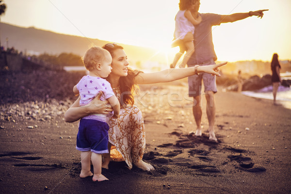 Happy family on a tropical beach Stock photo © konradbak