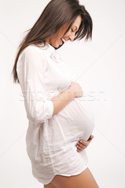 Standing happy pregnant woman in profile Stock photo © konradbak