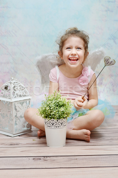 Stock photo: Laughing cute witch with wand
