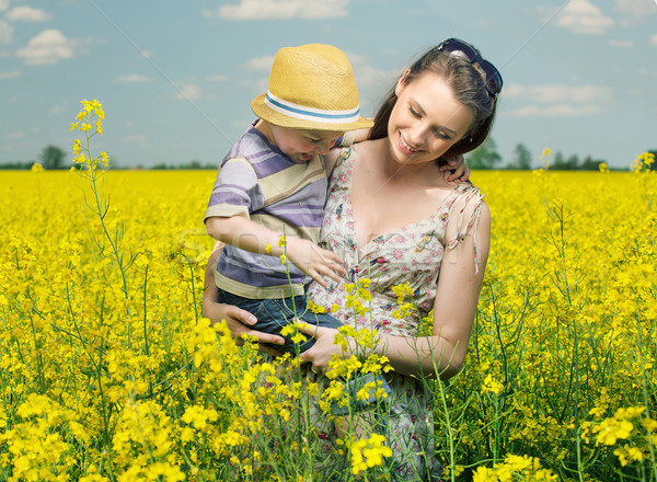 Walking among the canola flowers Stock photo © konradbak