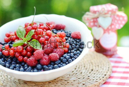 Stock photo: Fresh berries and raspberry jam, served in the garden