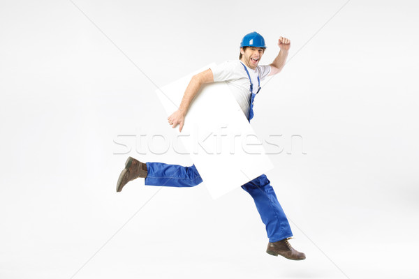 Happy young engineer running with board Stock photo © konradbak