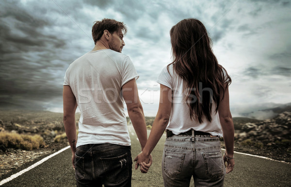 Two hitchhikers walking along the road Stock photo © konradbak