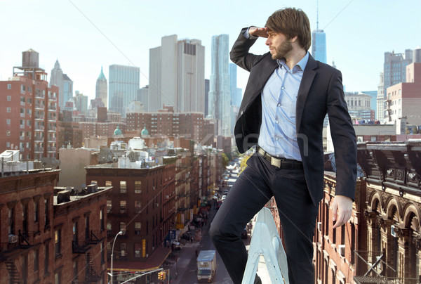 Handsome young man on the top of the city Stock photo © konradbak