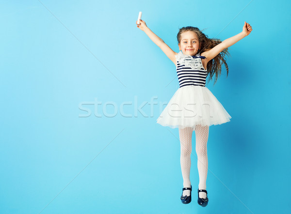 Stock photo: Charming girl holding a piece of chalk