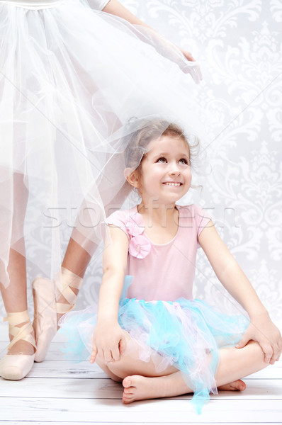 Stock photo: Little girl next to the ballet dancer