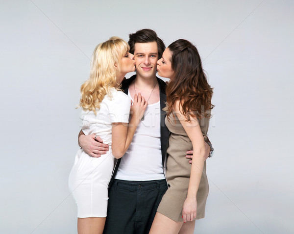 Lucky guy kissed by two fabulous women Stock photo © konradbak