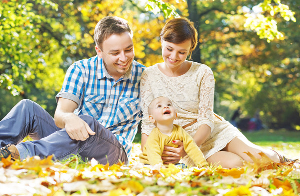 Glad parents observing their baby Stock photo © konradbak