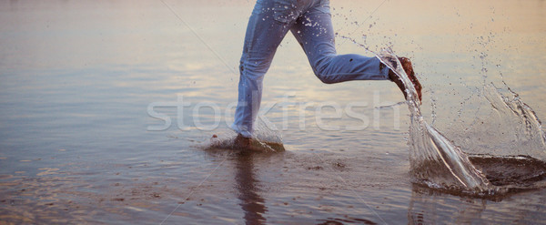 Man running into the sea water Stock photo © konradbak