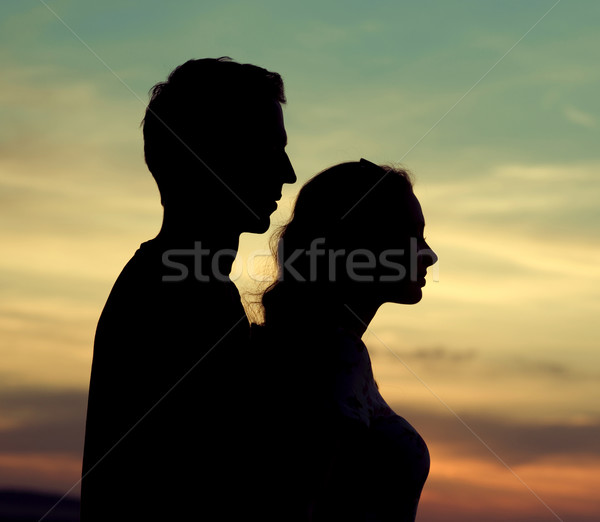 Silhouettes of the young couple Stock photo © konradbak
