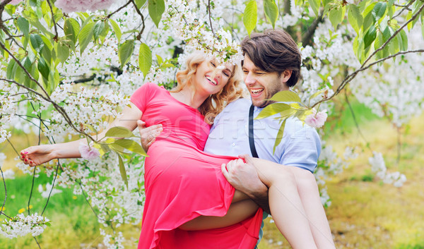 Joyful couple in the fragrant orchard Stock photo © konradbak