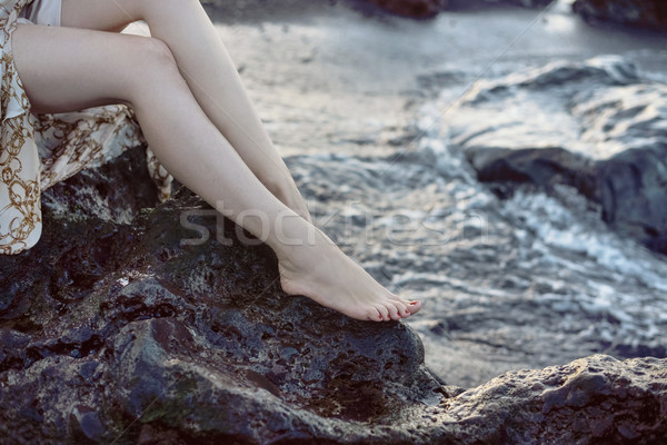 Pretty lady sitting on the sharp rock Stock photo © konradbak