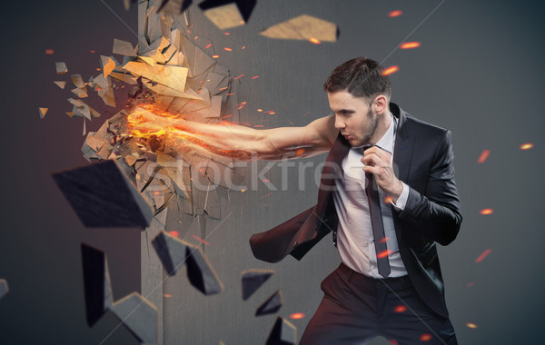 Conceptual portrait of a businessman beating a barrier Stock photo © konradbak