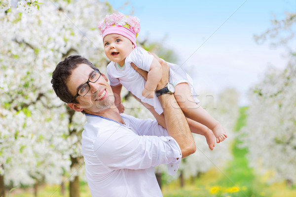 Cheerful father holding his beloved child Stock photo © konradbak