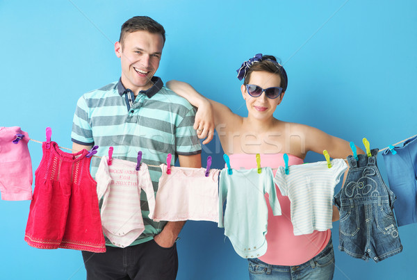 Amused parents doing the laundry Stock photo © konradbak