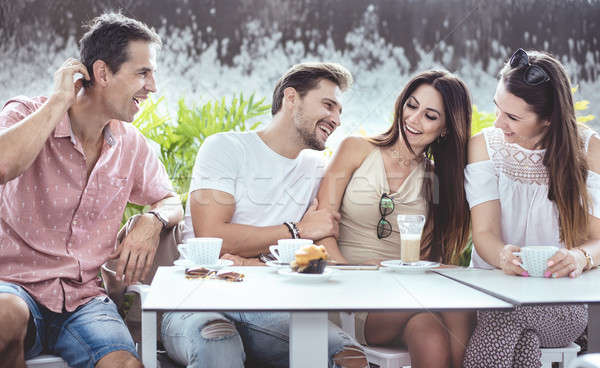 Stock photo: Group of cheerful friends in the coffe house