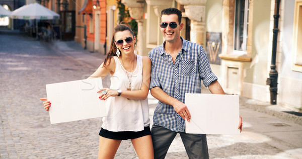 Two smiling people holding white bard Stock photo © konradbak