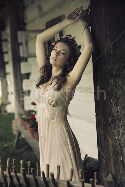 Sensual sexy woman posing next to the wooden house Stock photo © konradbak