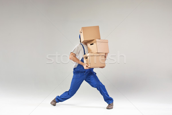Hard-working builder holding paper boxes Stock photo © konradbak