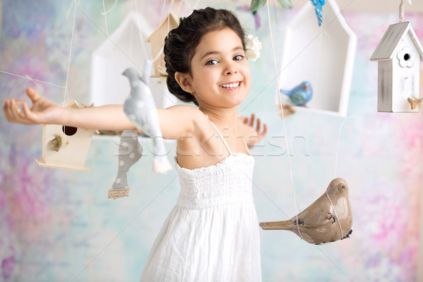 Joyful girl among wooden birds Stock photo © konradbak