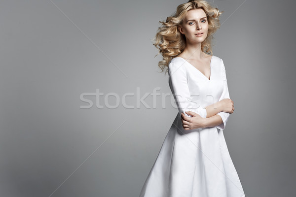 Stock photo: Pretty young woman with a curly haristyle