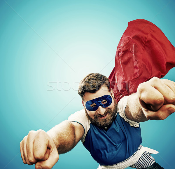 Plump superheroe flying over the city Stock photo © konradbak