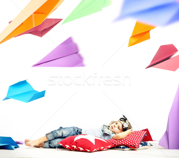 Little pilot observing plenty of paper planes Stock photo © konradbak