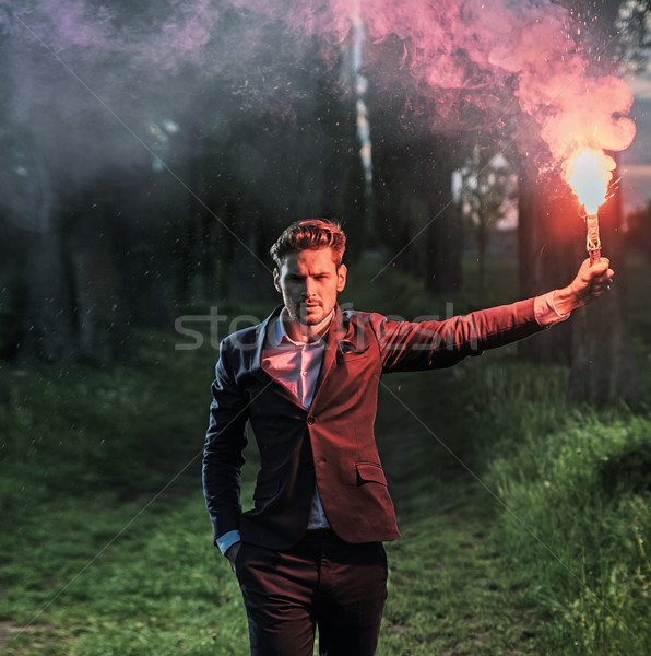Conceptual portrait of an ambitious businessman holding a flare Stock photo © konradbak